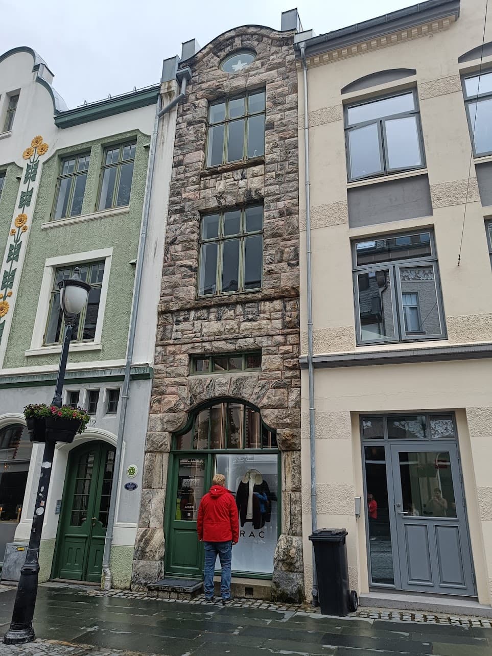 Historic façades in Ålesund with stonework, original windows and decorative details